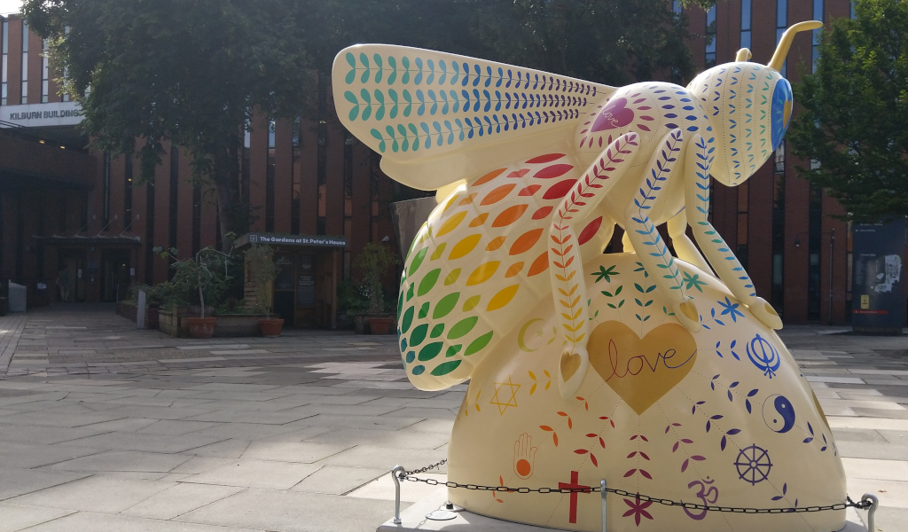 Photo of the The Love Bee in front of Kilburn Building