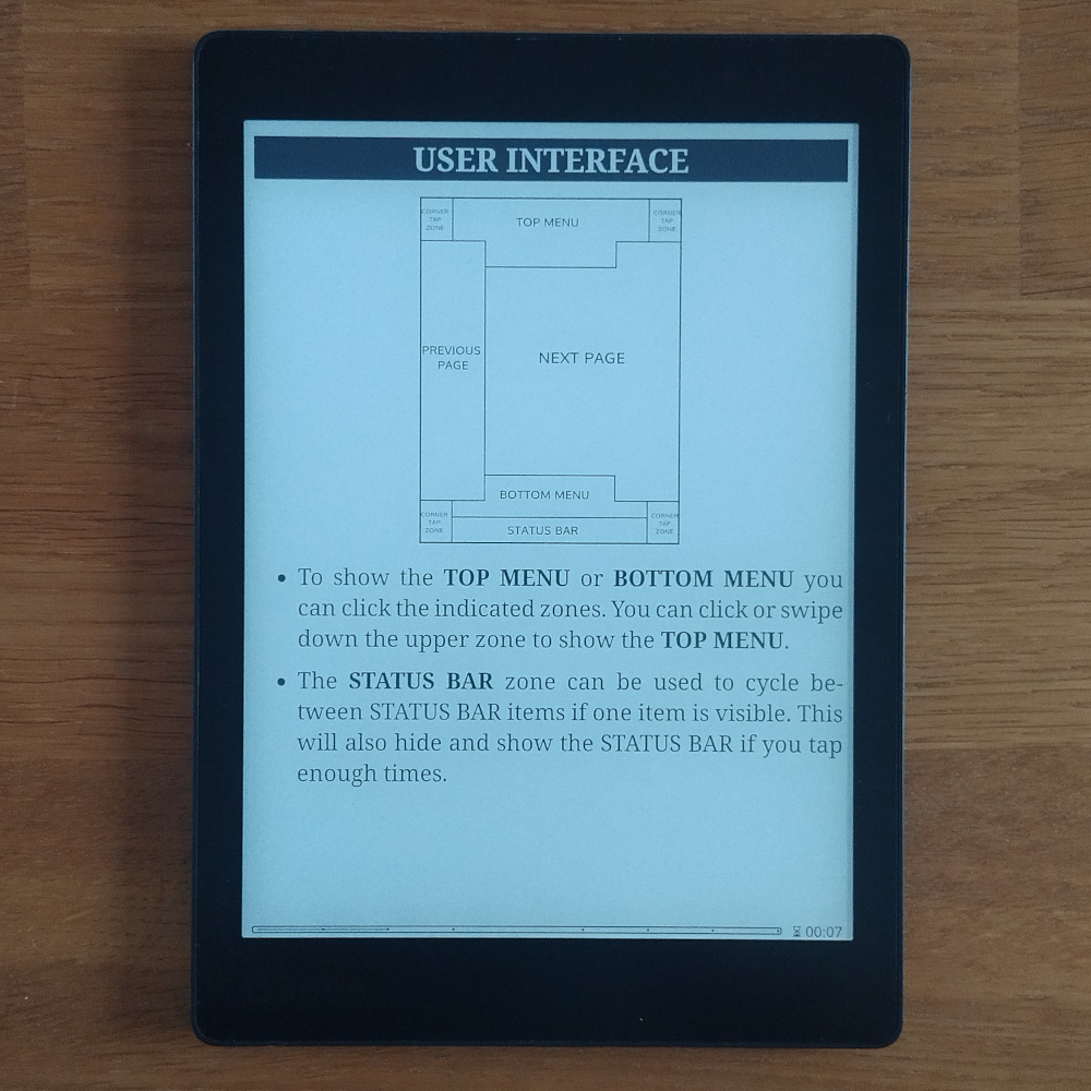 Photo of Kobo showing page of KOReader manual showing the tap zones.